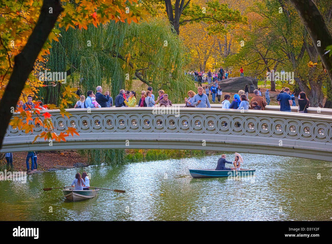 Visitors taking in the sights from the Bow Bridge in Central Park, New York, USA Stock Photo