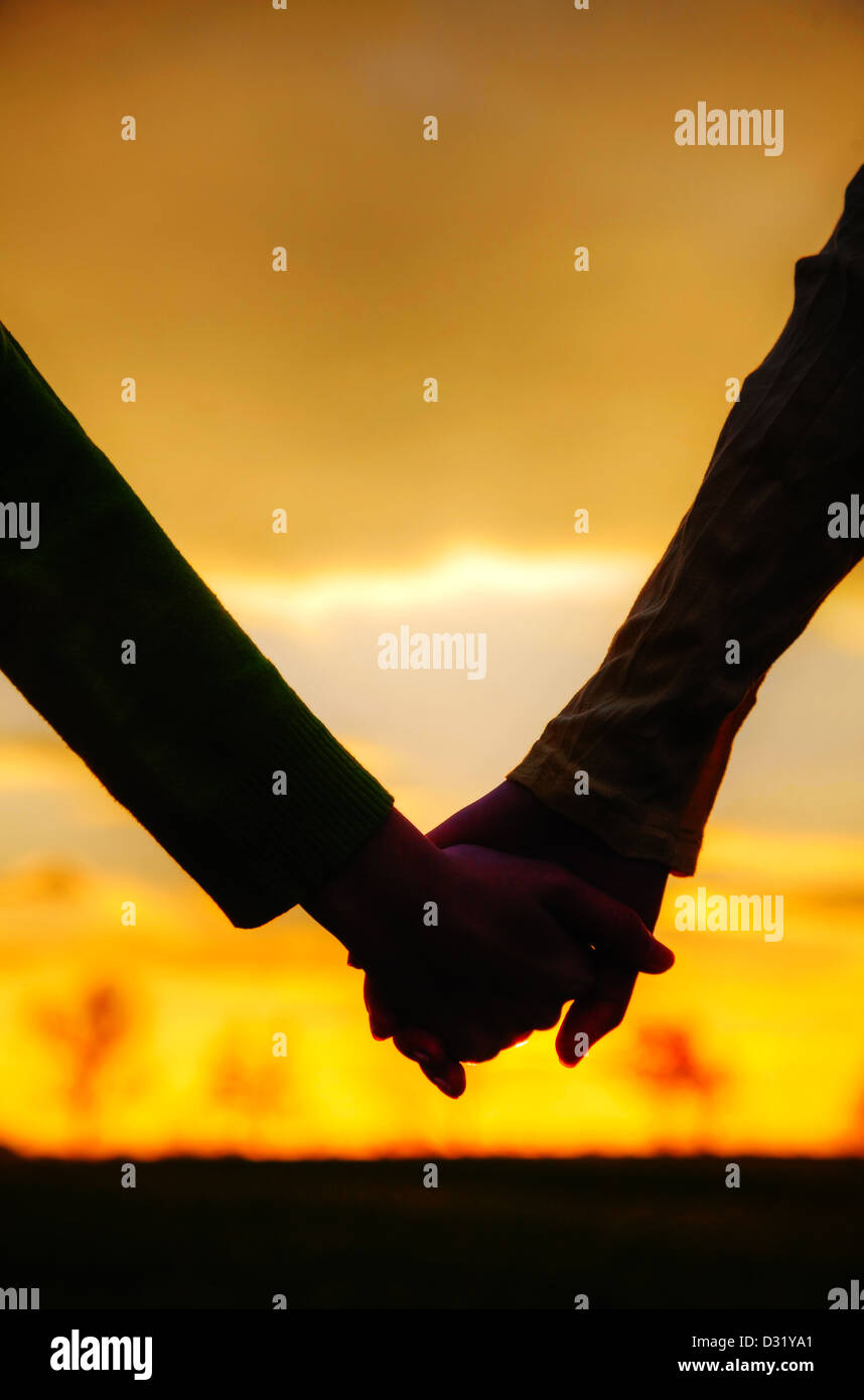 Teen girls holding hands at sunset time Stock Photo - Alamy