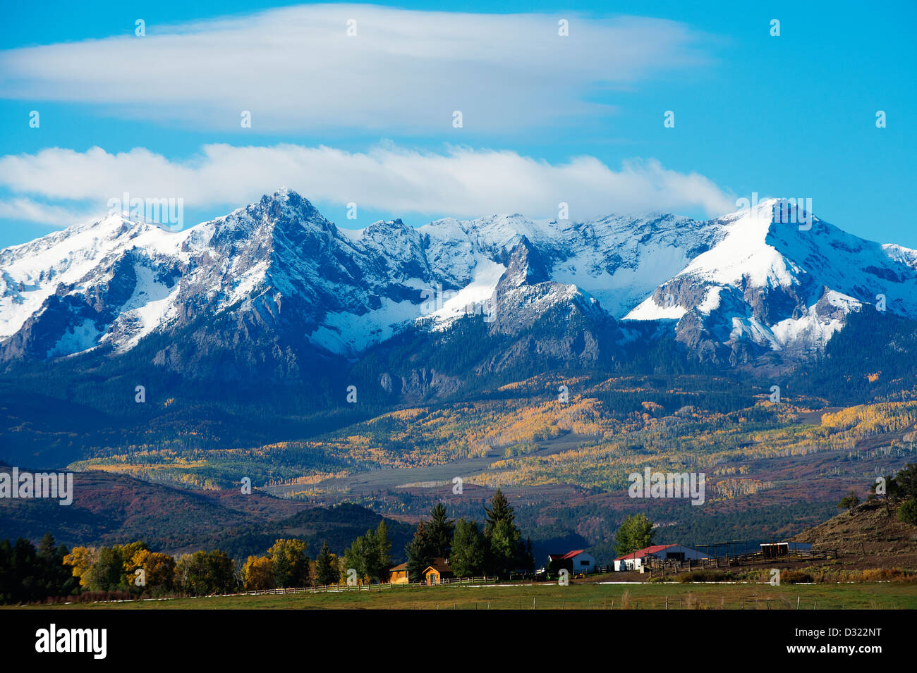 Snowy mountains overlooking rural landscape Stock Photo