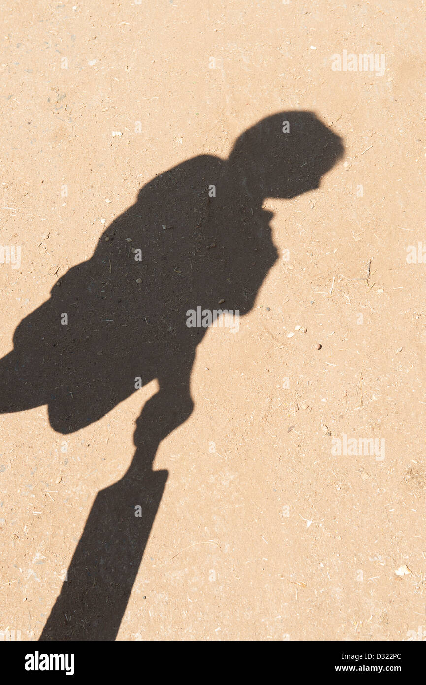 Shadow of young Indian boy with a cricket bat. India Stock Photo