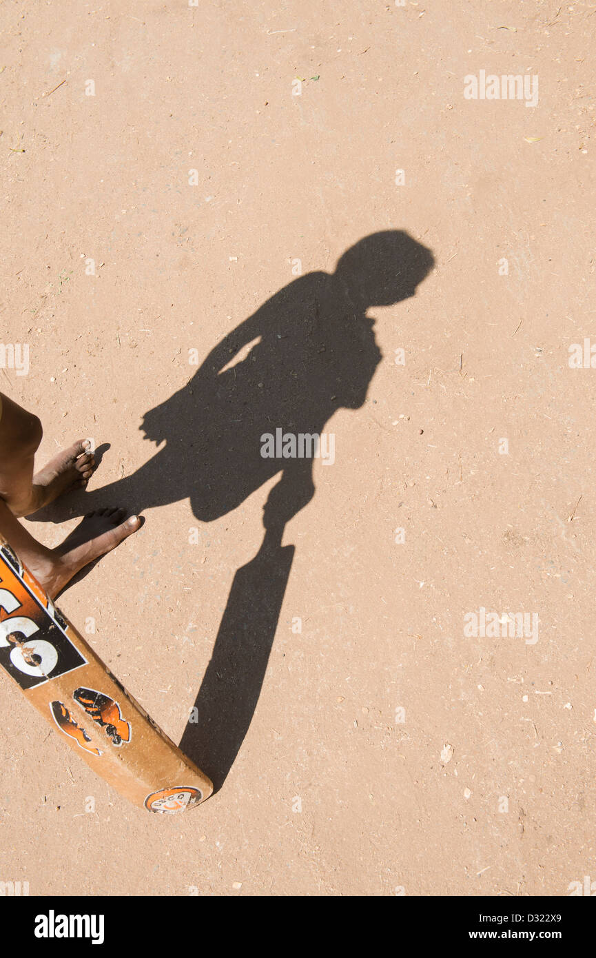 Shadow of young Indian boy with a cricket bat. India Stock Photo