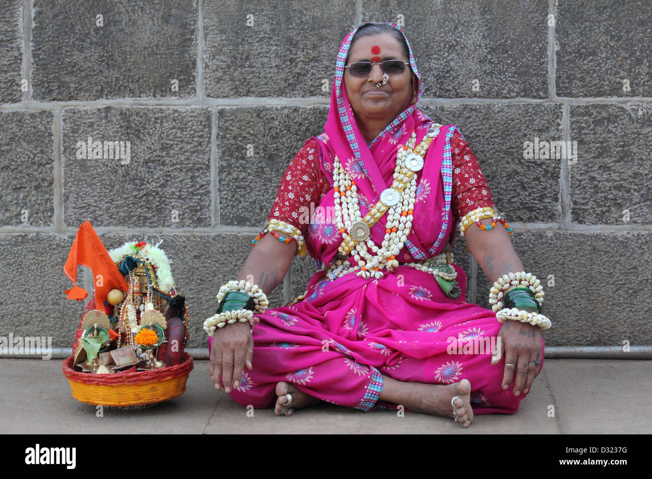 Old Lady sitting in front Bhimasankar Temple In traditional dress Stock Photo