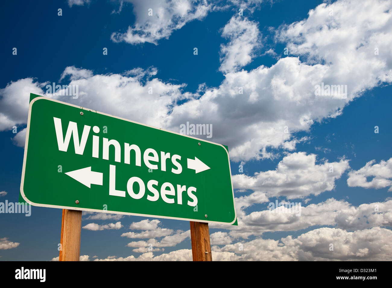 Winners, Losers Green Road Sign Over Dramatic Clouds and Sky. Stock Photo