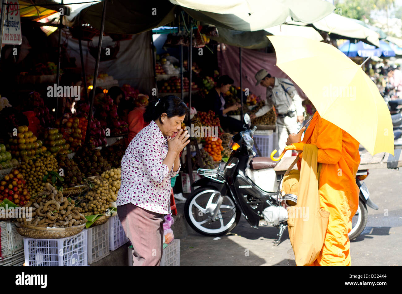 Women pays respect to Buddhist monk ,Old Market, Phnom Penh Stock Photo