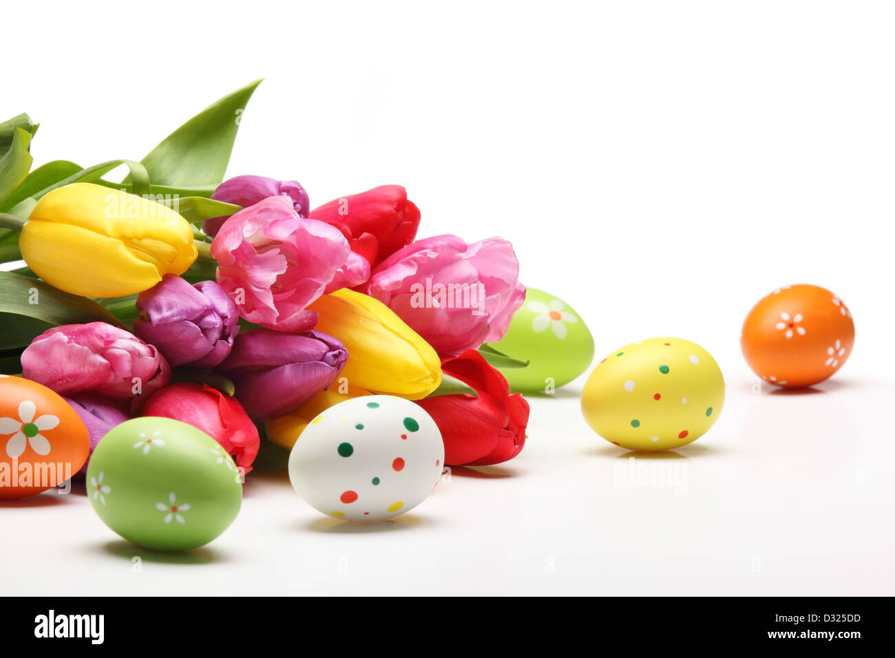Easter eggs with tulips on white background Stock Photo - Alamy