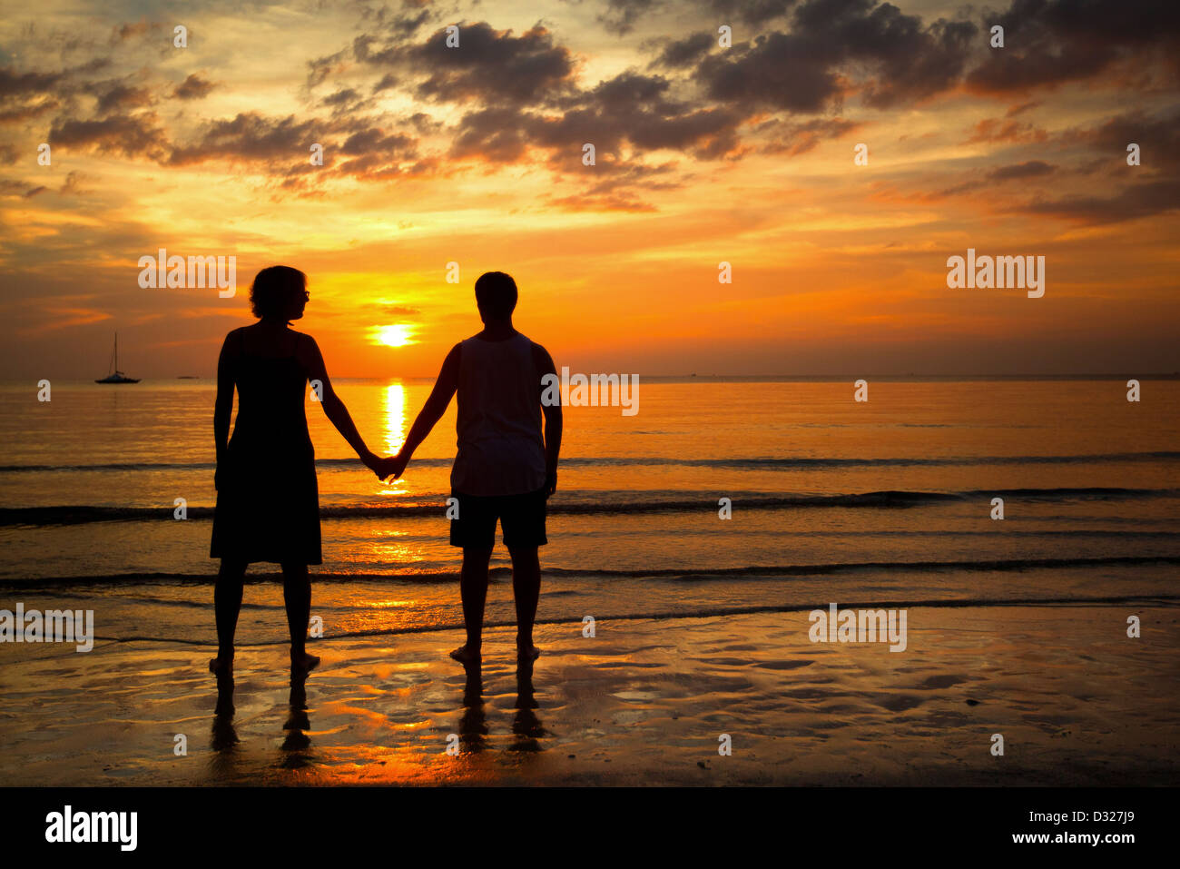 Romantic picture: Silhouettes young couple on the beach at sunset Stock ...