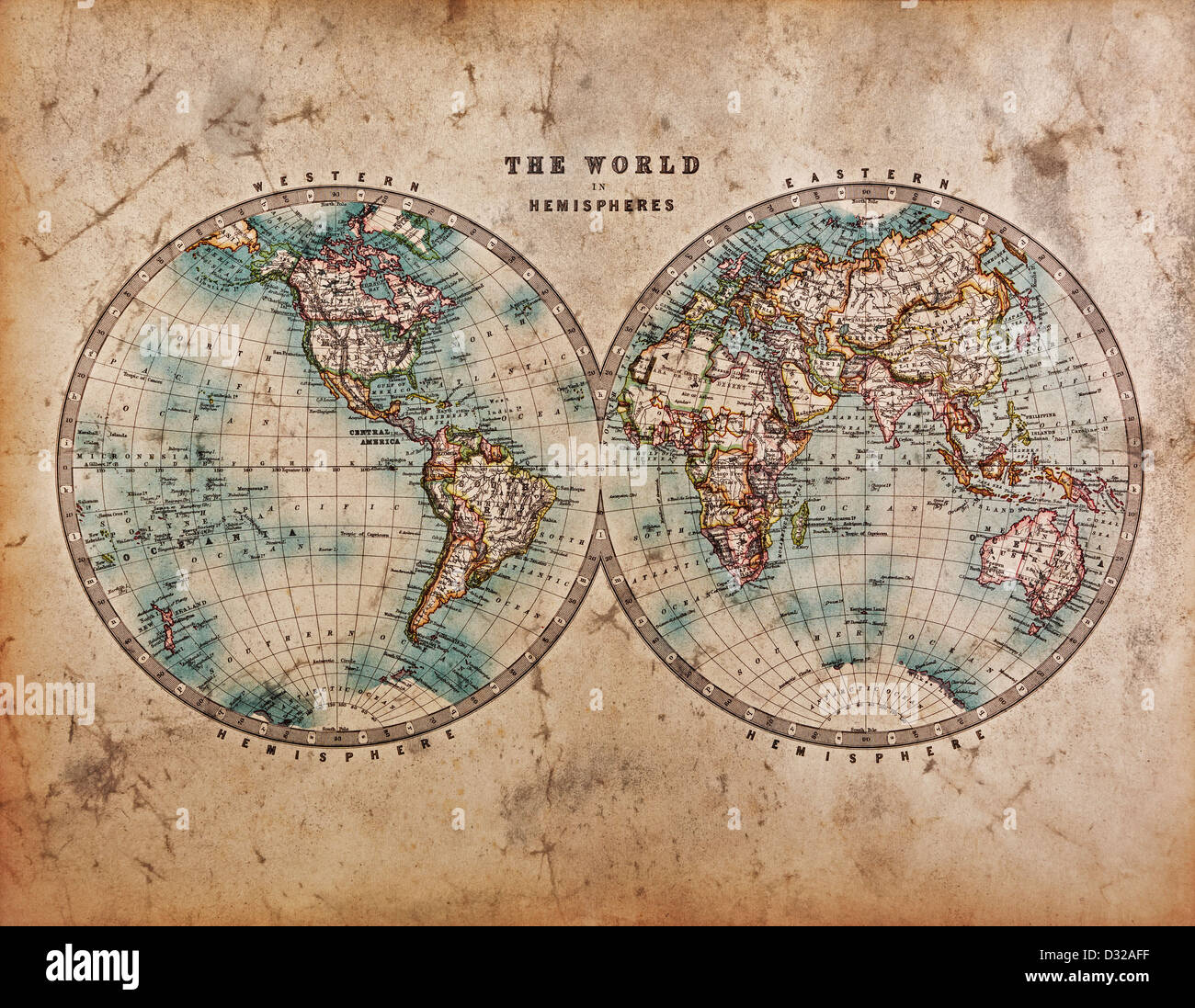 A genuine old stained World map dated from the mid 1800's showing Western and Eastern Hemispheres with hand colouring. Stock Photo