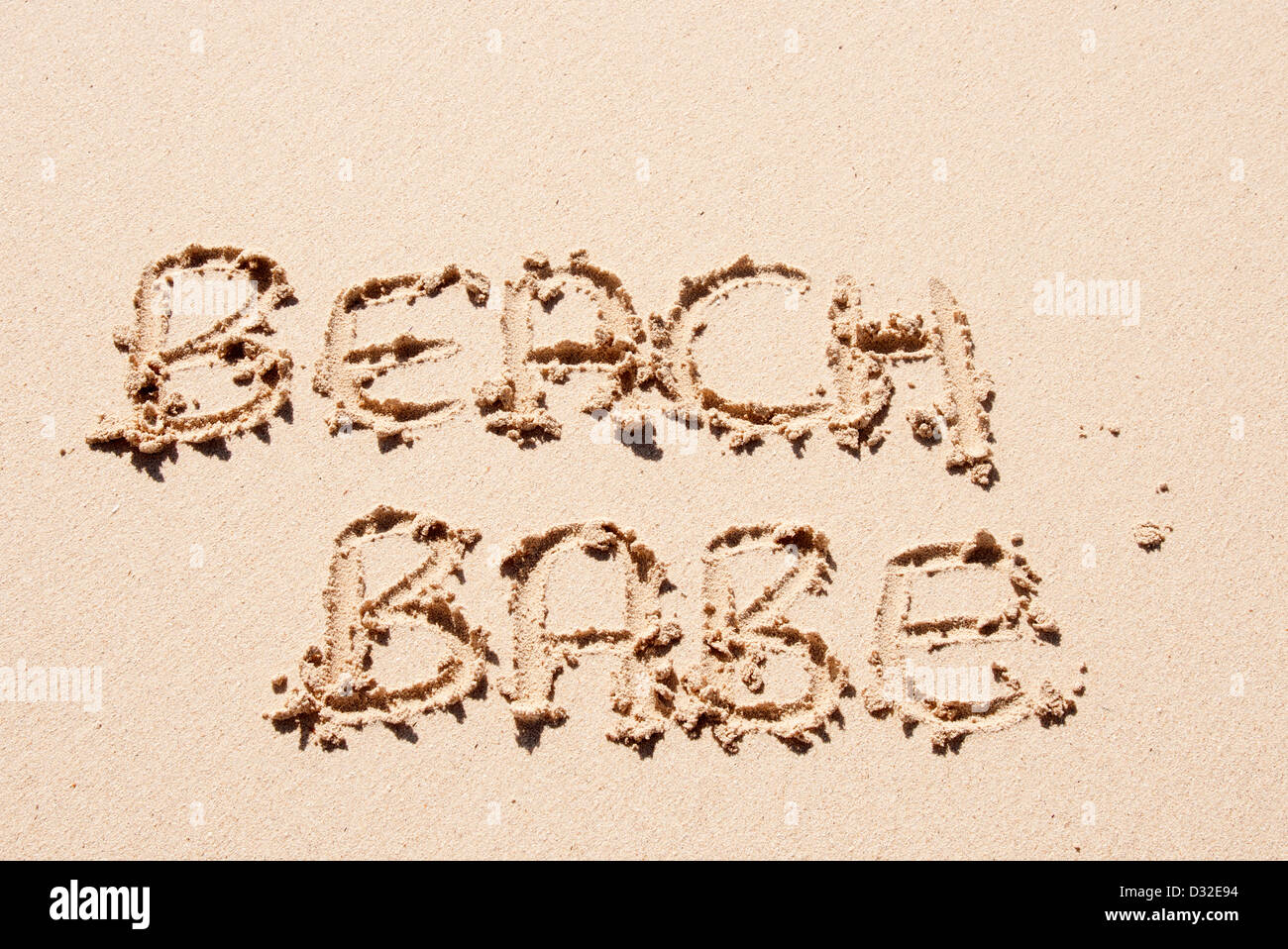 beach babe written in sand on a beach Stock Photo