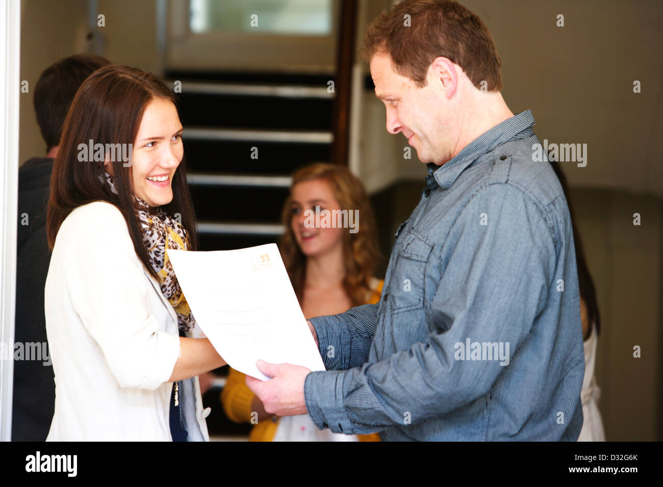 A young person being presented with their college degree having graduated Stock Photo