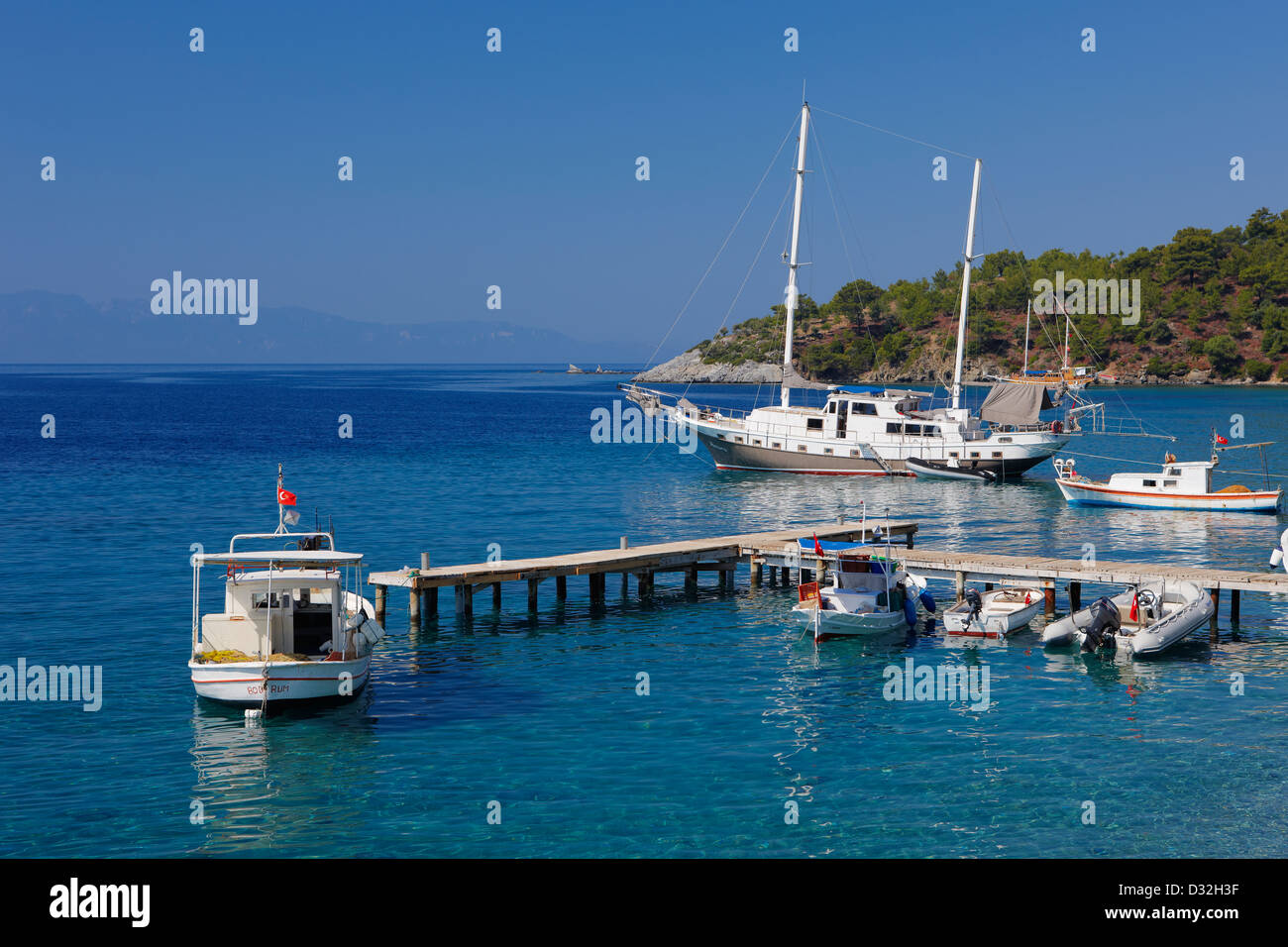 Pier with moored boats near Mazi village. Bodrum peninsula, Turkey. Stock Photo