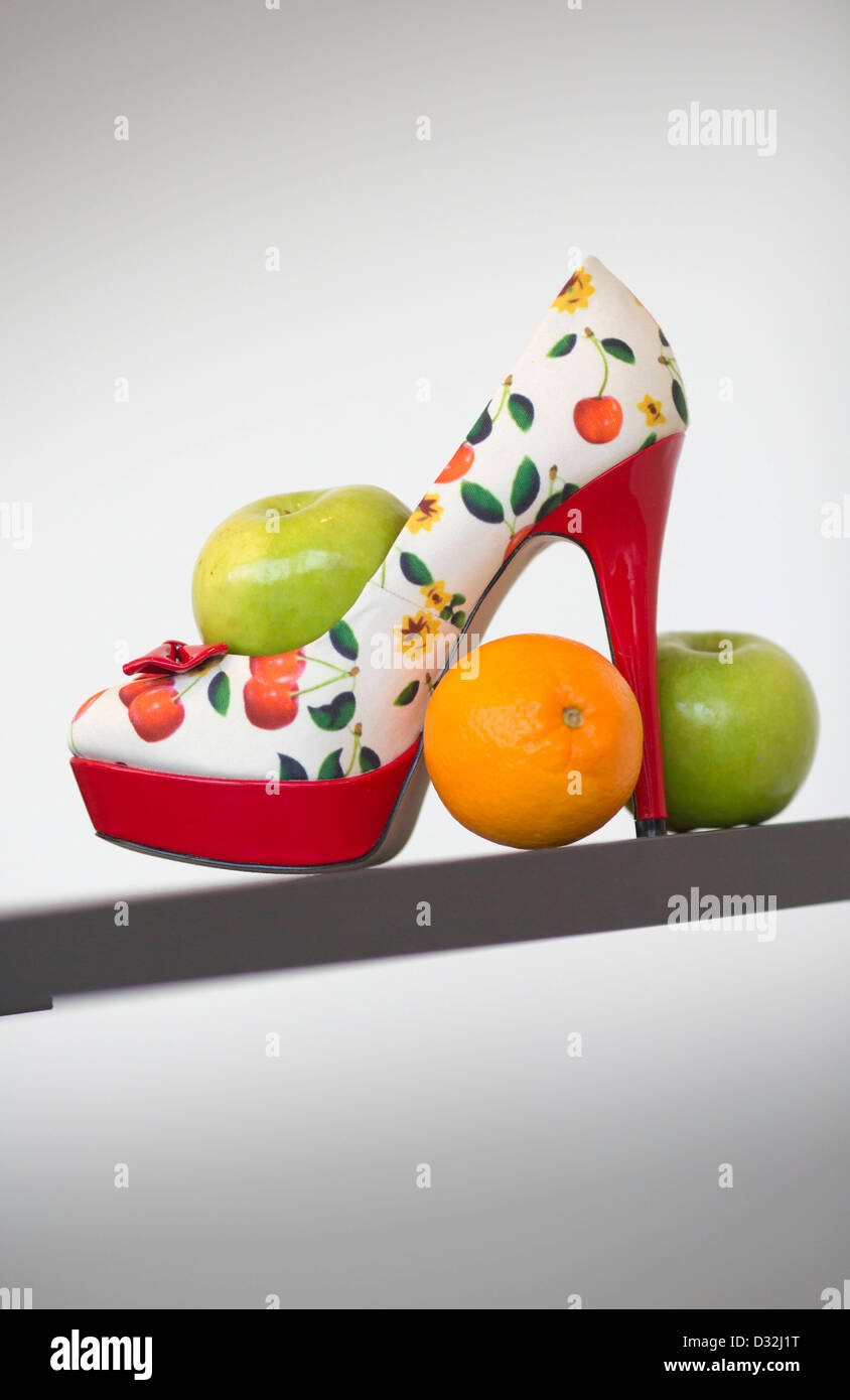 A show with fruit and flower motives sits between apples and oranges in Frankfurt Main, Germany, 07 February 2013. The German Shoe Institute is unveiling its shoe and bag trends for spring and summer 2013. Photo: FRANK RUMPENHORST Stock Photo