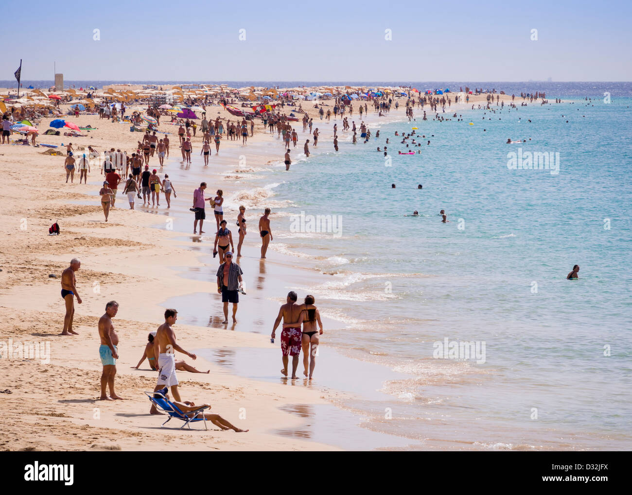 Tourists populate the beach Playa del Matorral, Jandia, Fuerteventura, Canary Islands. Stock Photo