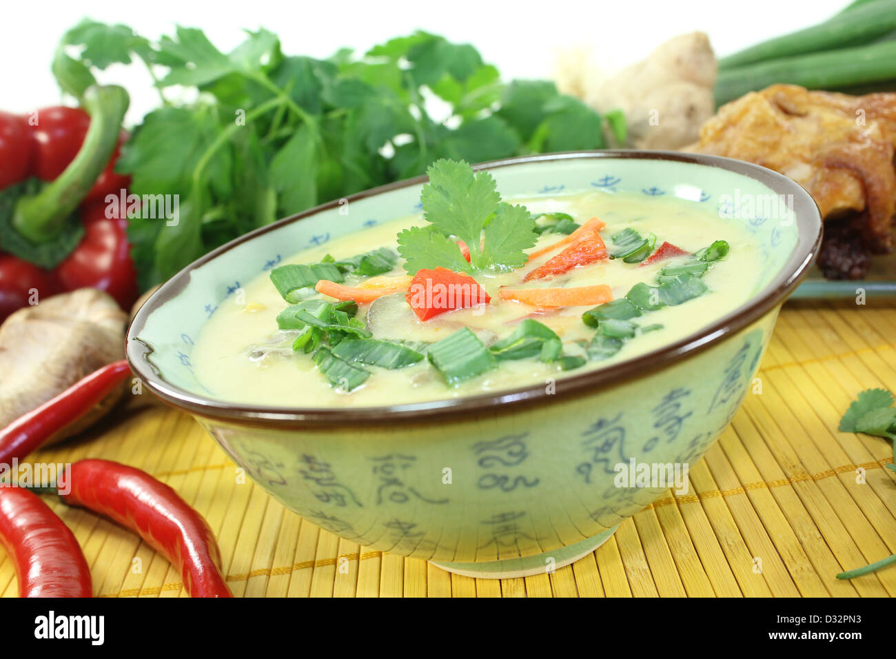 Curry soup with chicken, bell peppers, coconut milk, scallions, red