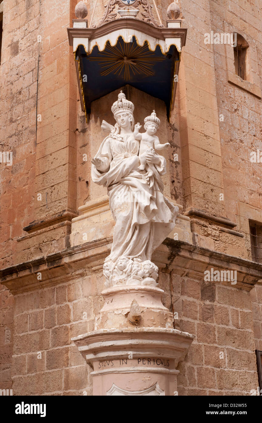 Mdina, Malta, stone sculpure on corner of building at high level, inscription,ornate,sunny, shadows Stock Photo