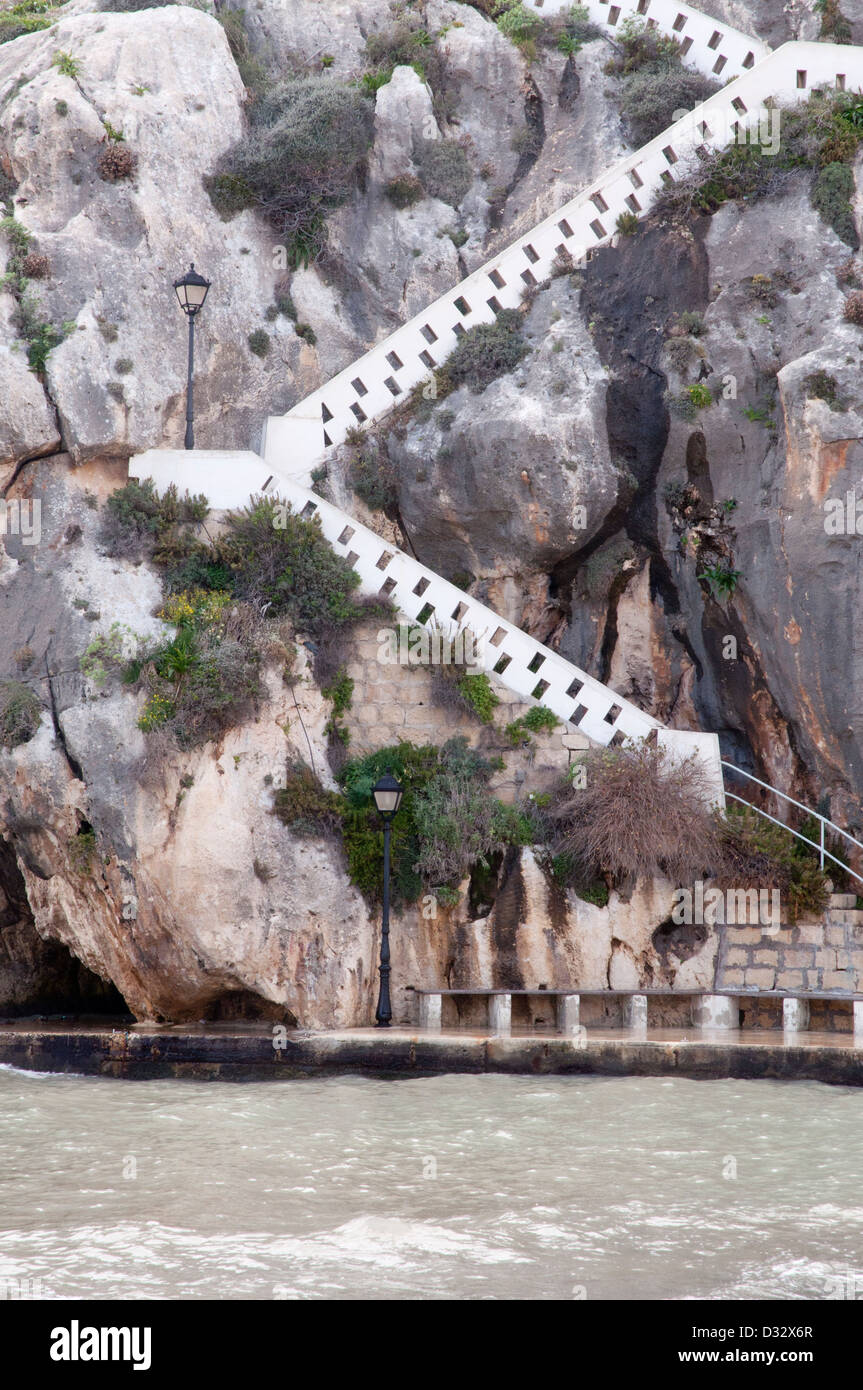 cliff face with covered stairs enclosing stairs rising externally up