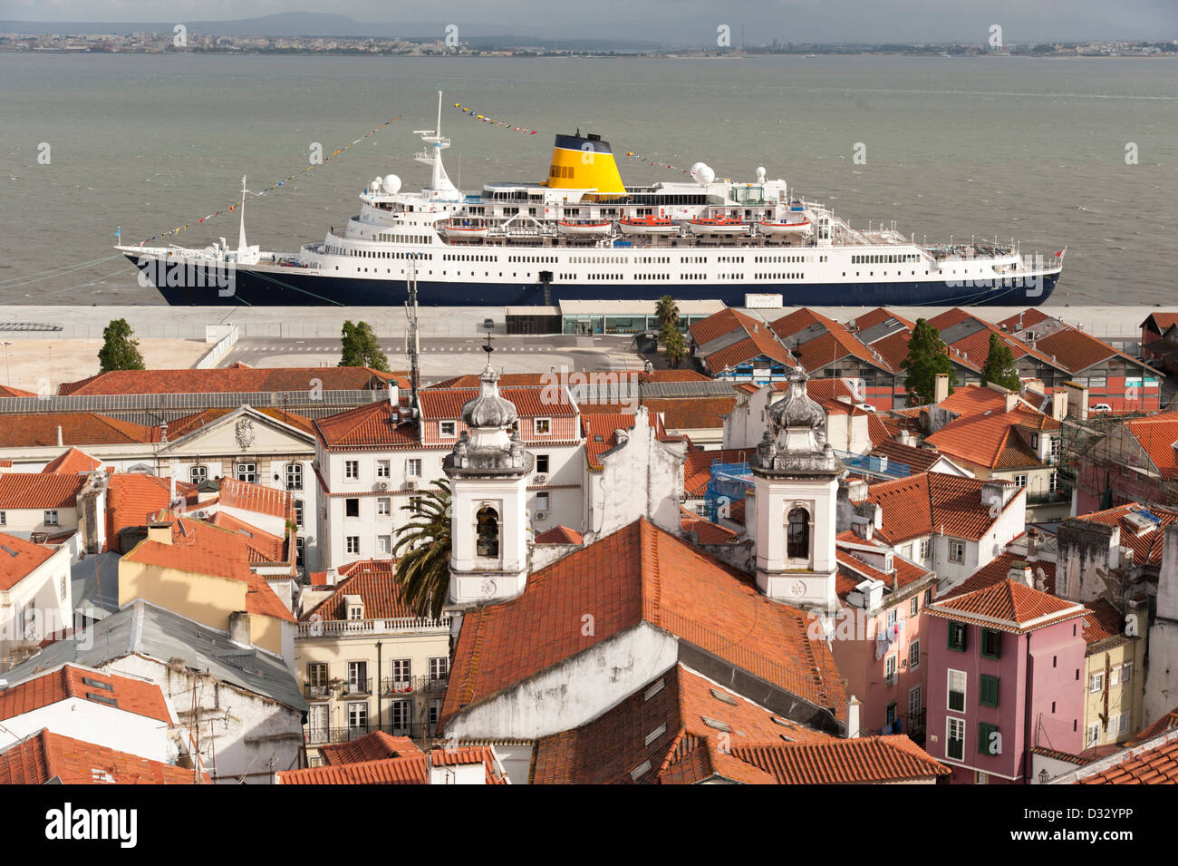 Rooftops of Alfama and the Saga Ruby cruise ship on the Tejo river, Lisbon, Portugal Stock Photo