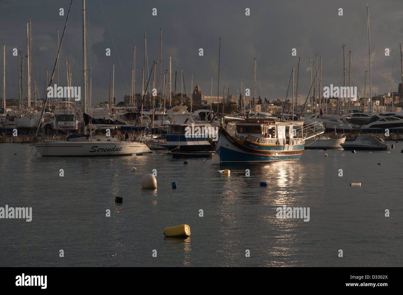 harbour scene, Sliema, Malta, Valetta, pleasure boats, masts, calm water, grey sky, rainy, grey clouds,promenade, building Stock Photo