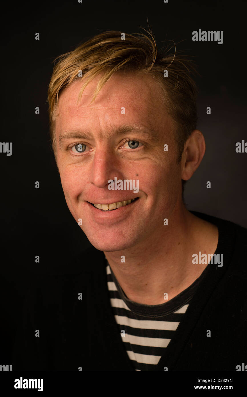 A slim blonde man male, late 30's / early 40's, single solo alone, smiling happy confident, UK Stock Photo
