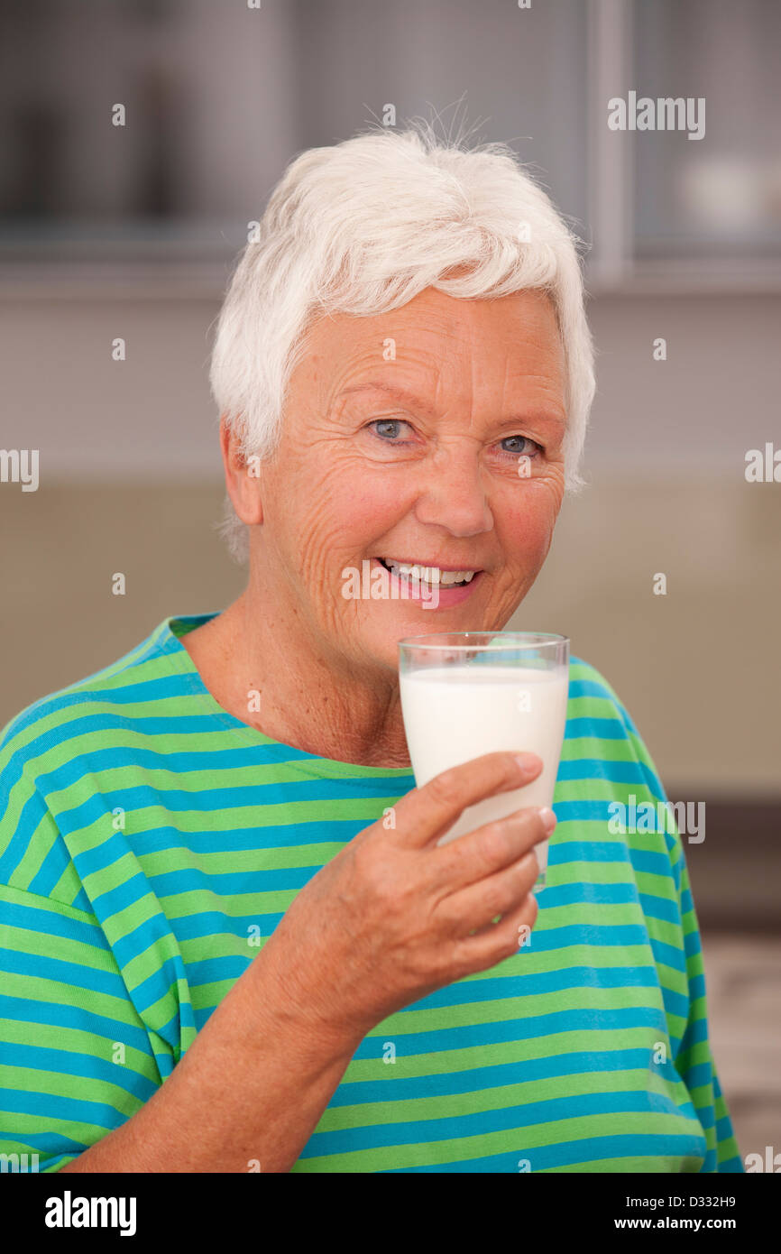 Elderly lady drinking milk Stock Photo Alamy