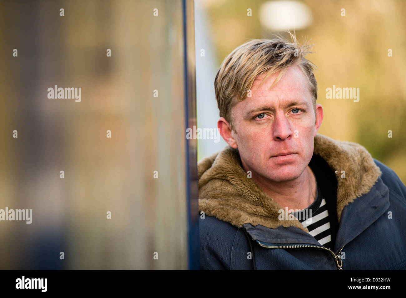 A slim blonde man male, late 30's / early 40's, single solo alone, looking sad UK Stock Photo