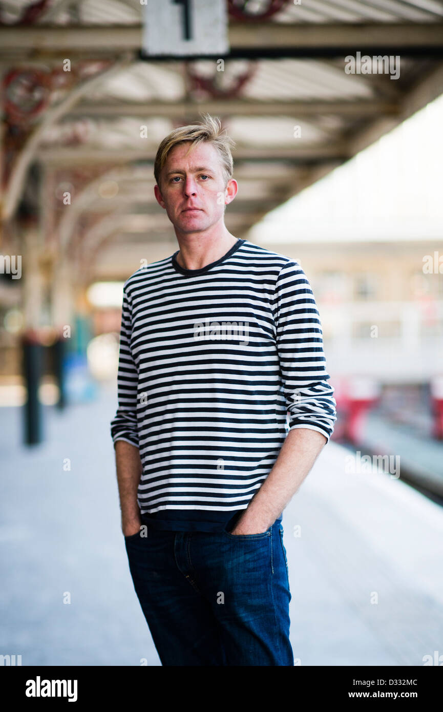 A slim blonde man male, late 30's / early 40's, single solo alone, looking sad UK Stock Photo