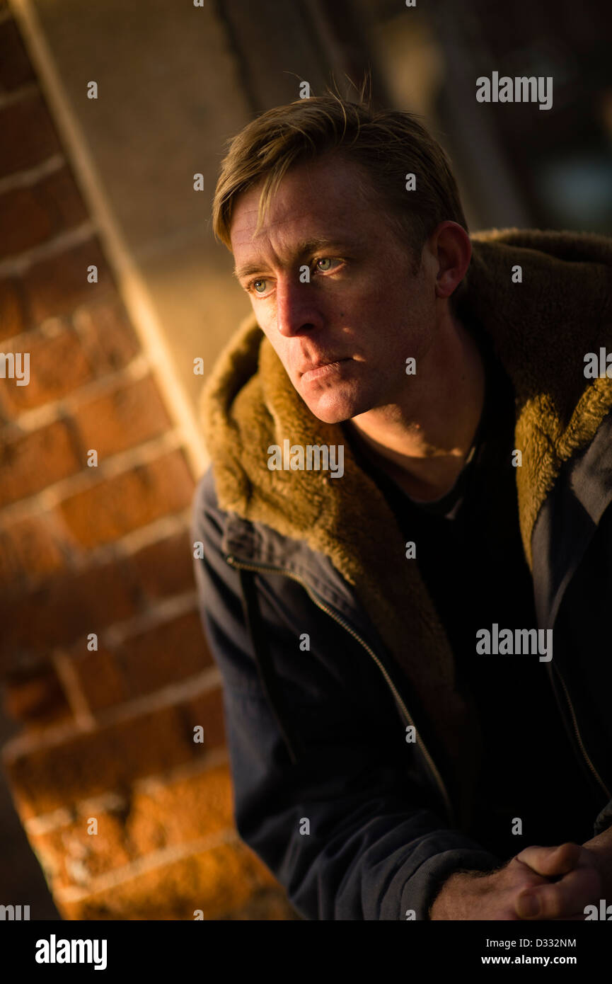 A slim blonde man male, late 30's / early 40's, single solo alone, looking sad UK Stock Photo