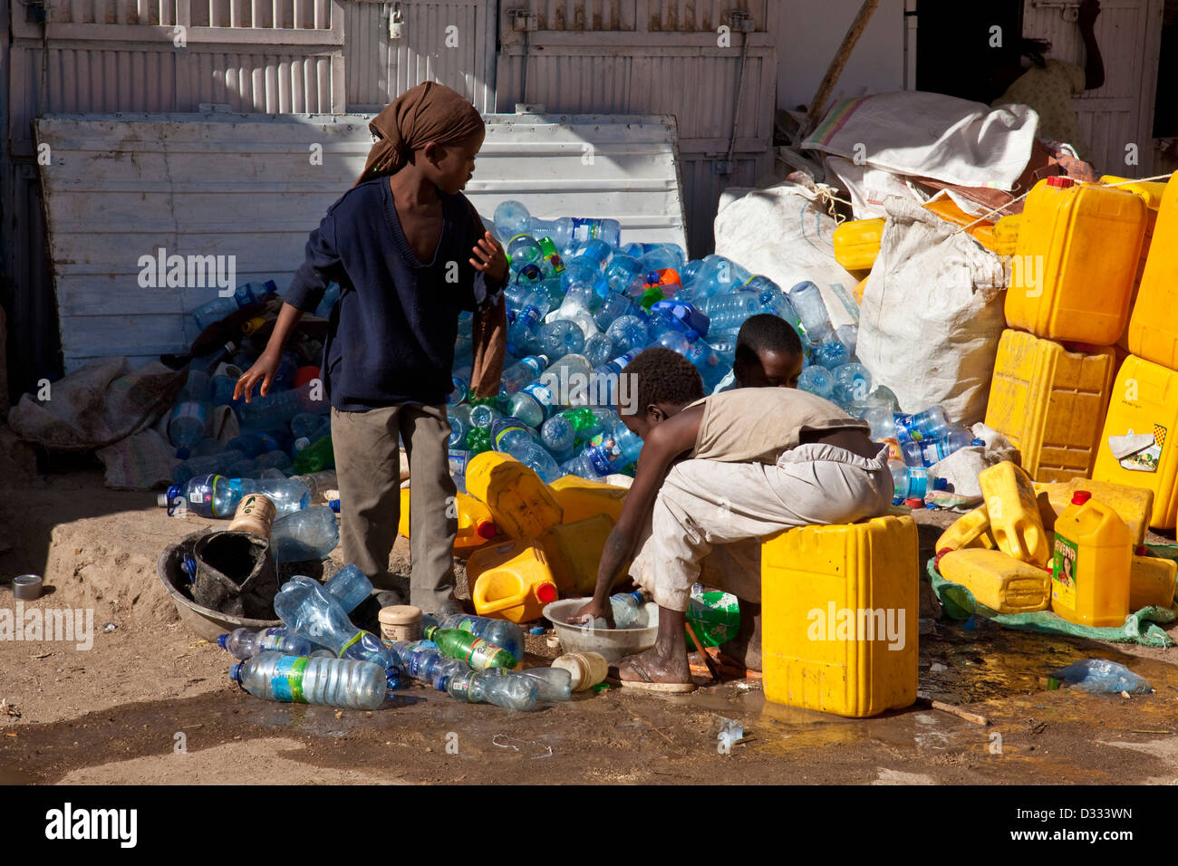 Children sorting out and cleaning plastic bottles and containers, Jugol (Old Town) Harar, Ethiopia Stock Photo