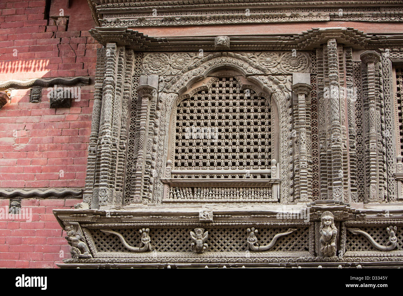 Ancient, ornately carved wood window frames on an old building in