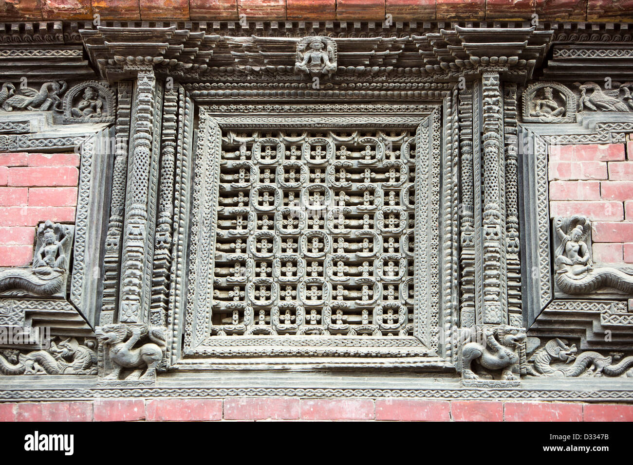 Ancient, ornately carved wood window frames on an old building in