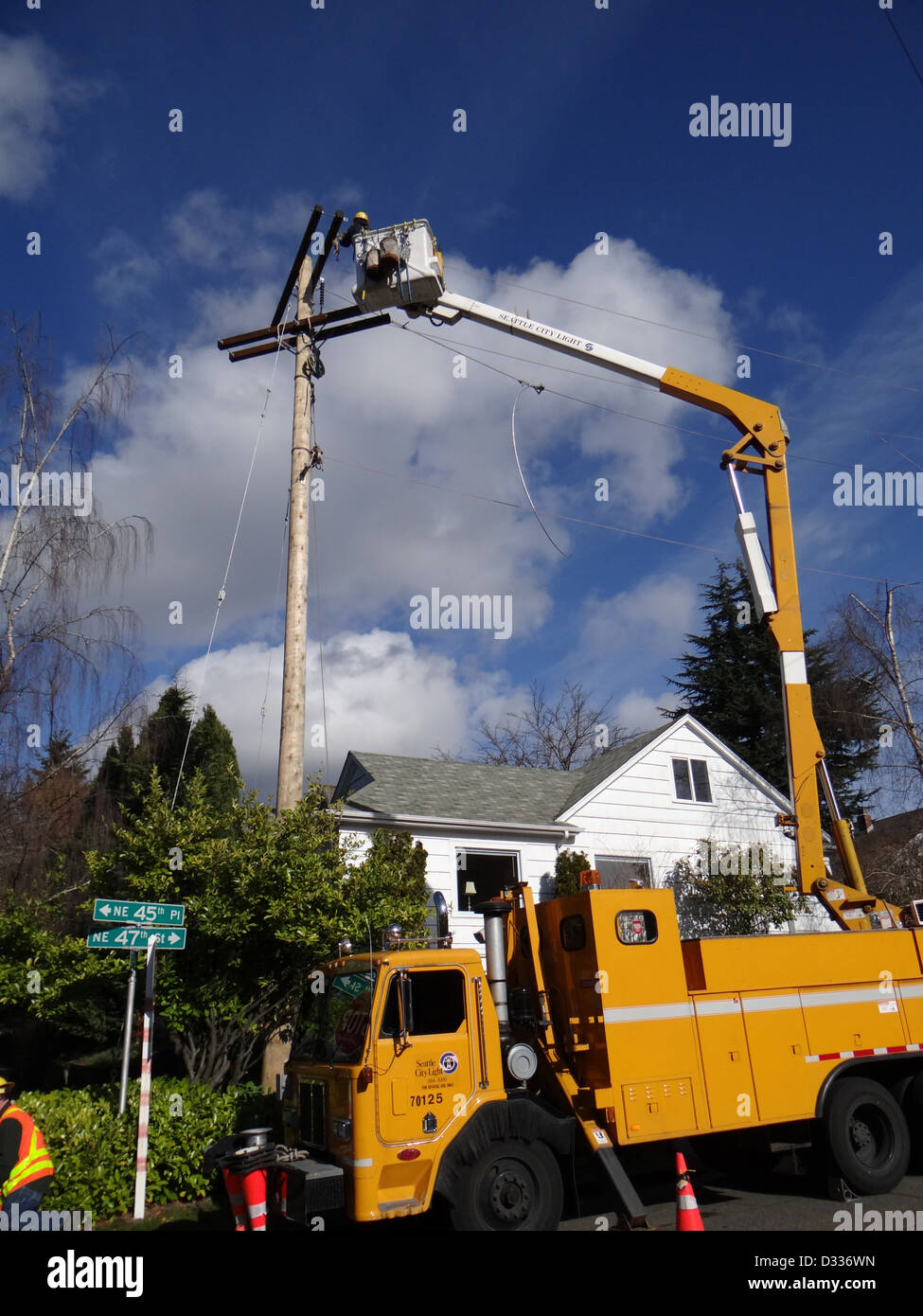 Seattle City Light workmen replace an aging utility pole as part of a city wide project to improve electrical reliability, on Feb 7, 2013 in Seattle. Stock Photo