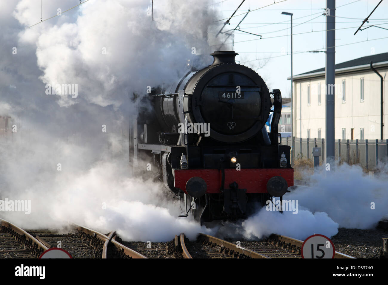46115 Scots Guardsman setting off from Carnforth on a test run emerges through a cloud of steam and smoke. Stock Photo