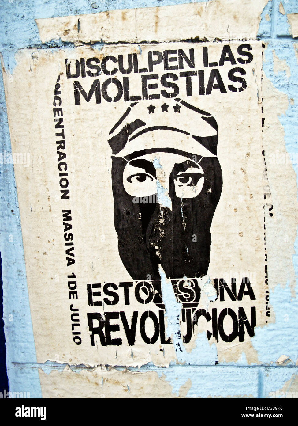 striking torn black & white revolutionary poster announcing long ago demonstration on pale blue plaster wall Oaxaca Mexico Stock Photo
