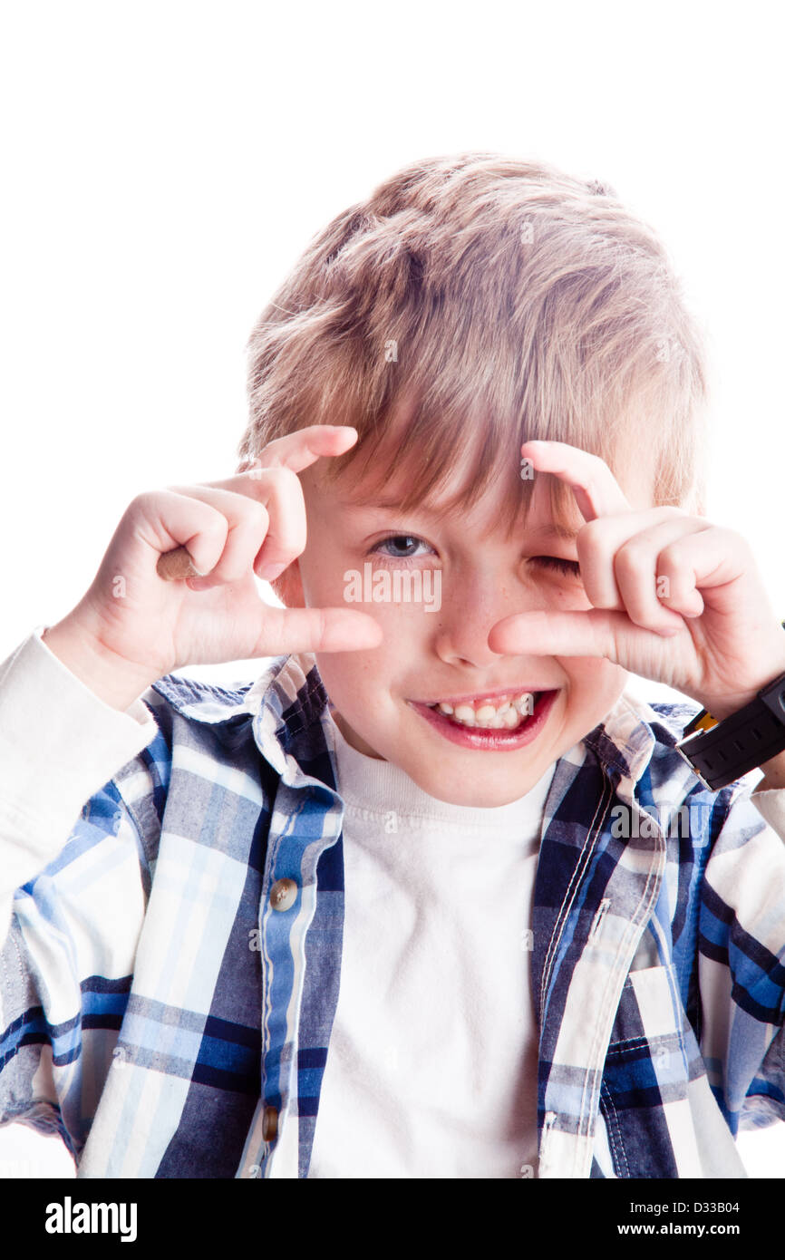 6 year old smiling blond boy pretends to take photograph. Stock Photo