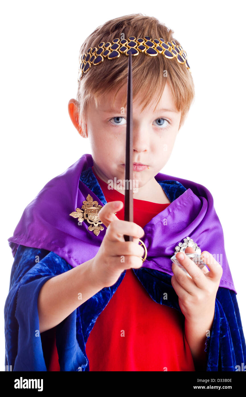 little boy pretends to be wizard kingl with magic wand. Stock Photo