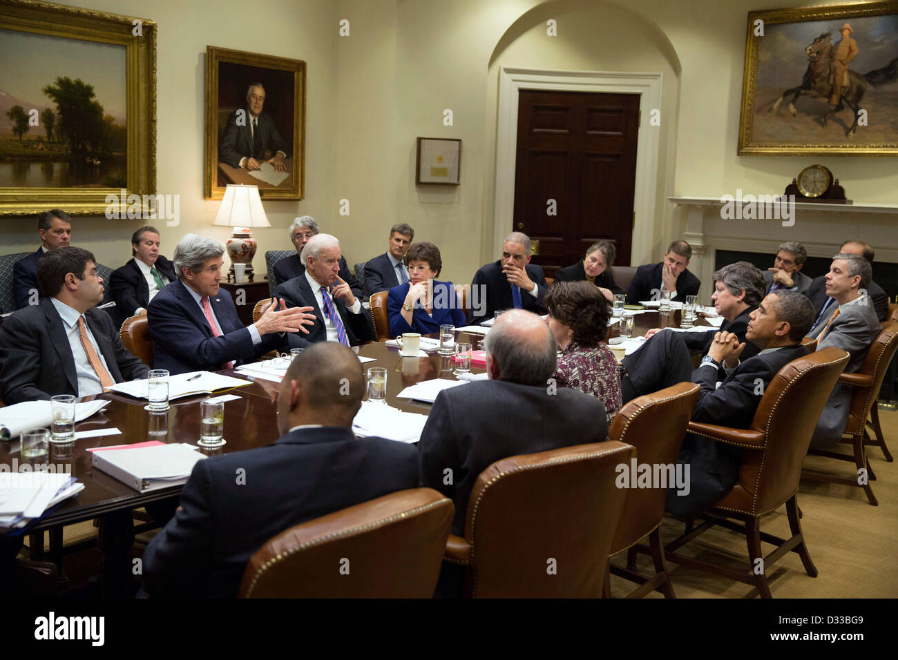 US President Barack Obama listens to Secretary of State John Kerry during a meeting on immigration with Cabinet members and advisors in the Roosevelt Room of the White House February 7, 2013 in Washington, DC. Stock Photo