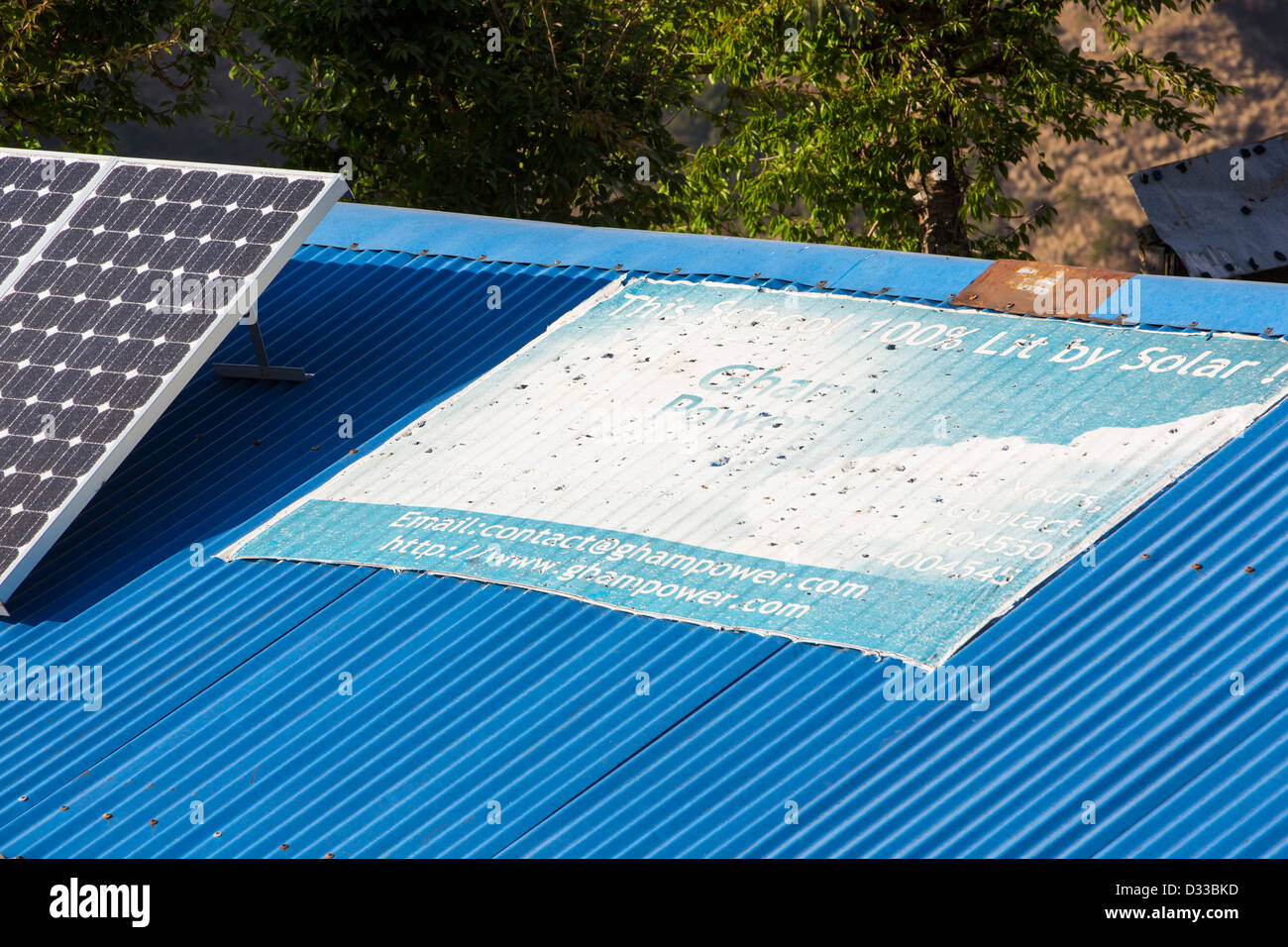 Solar photo voltaic panels on the rooftops of a school in Ladruk in the Himalayan foothills, Nepal. Stock Photo