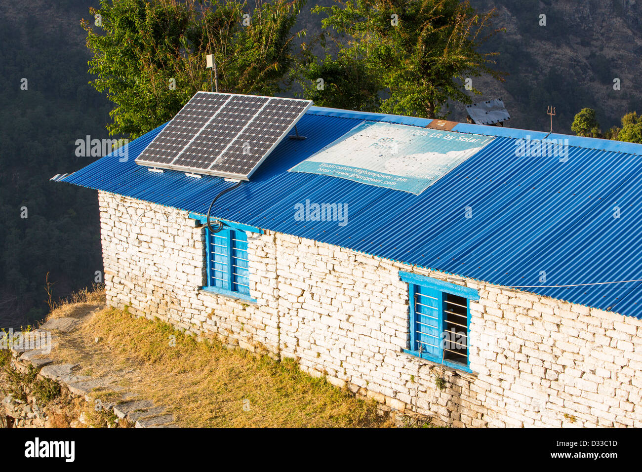 Solar photo voltaic panels on the rooftops of a school in Ladruk in the Himalayan foothills, Nepal. Stock Photo