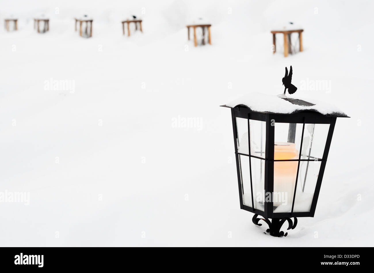 vintage Christmas lantern with a candle in the cemetery Stock Photo