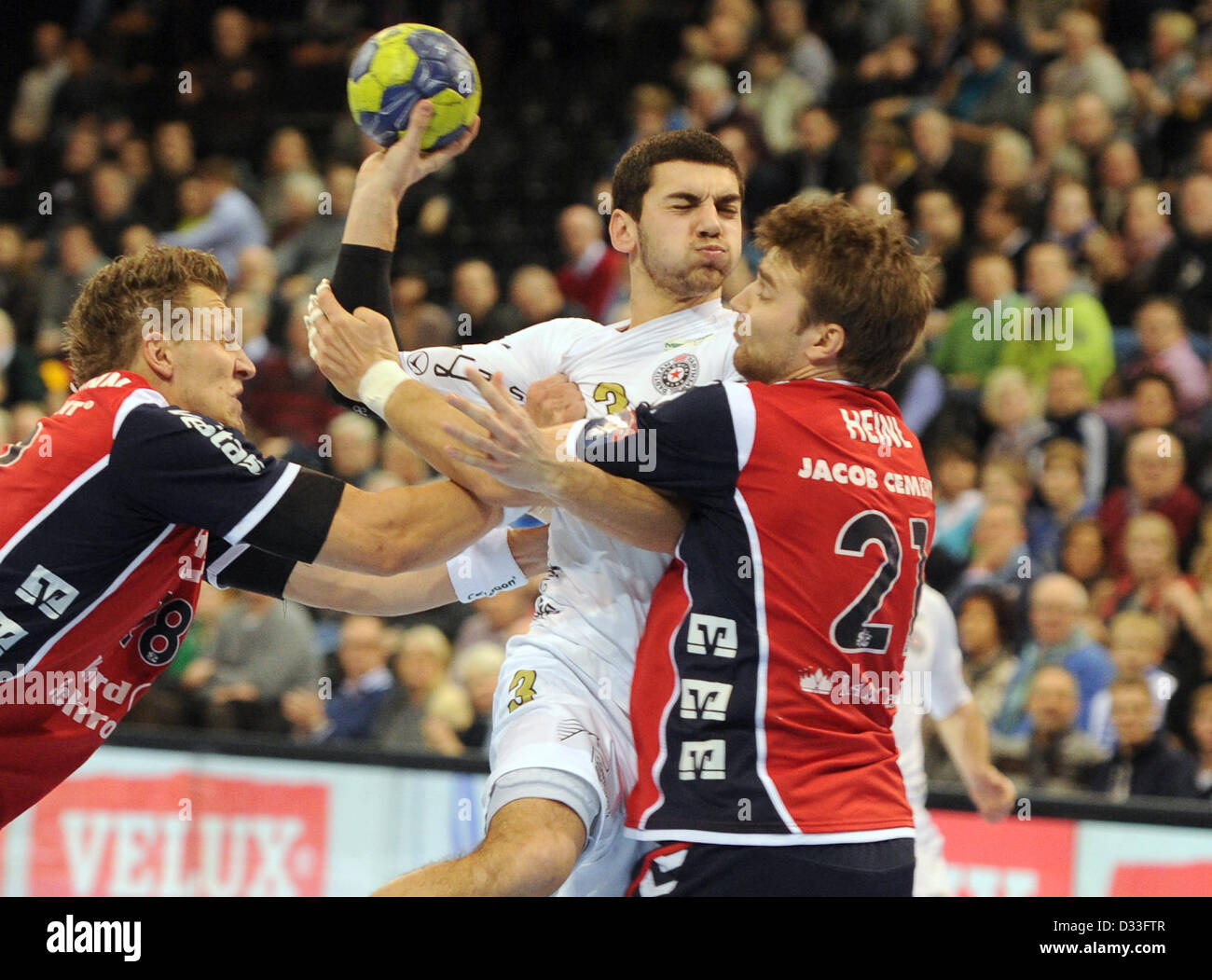 Flensburg-Handewitt's Lars Kaufmann (L) and Jacob Heinl and Belgrade's ...