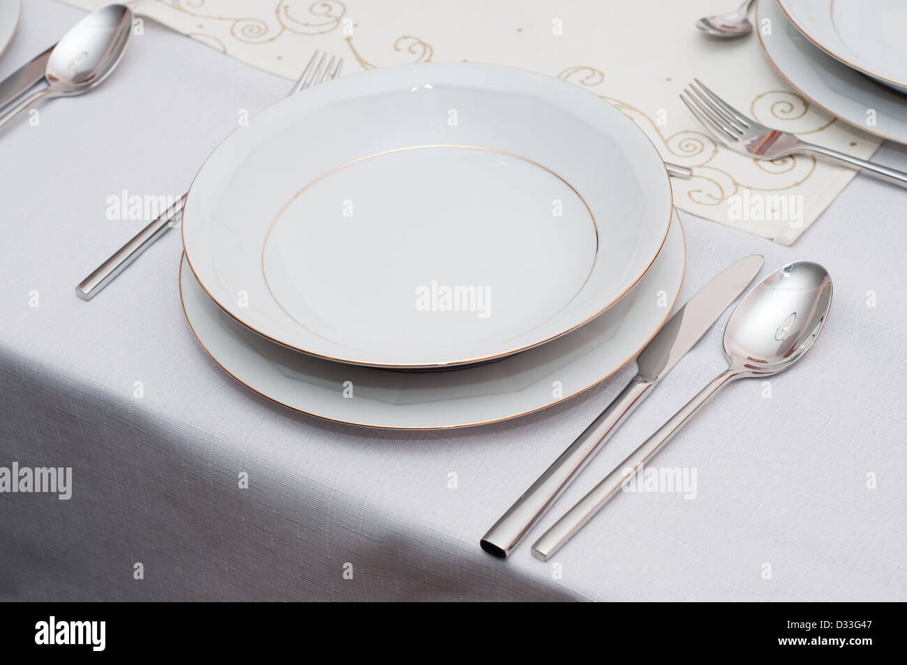 table with white porcelain plate Stock Photo - Alamy