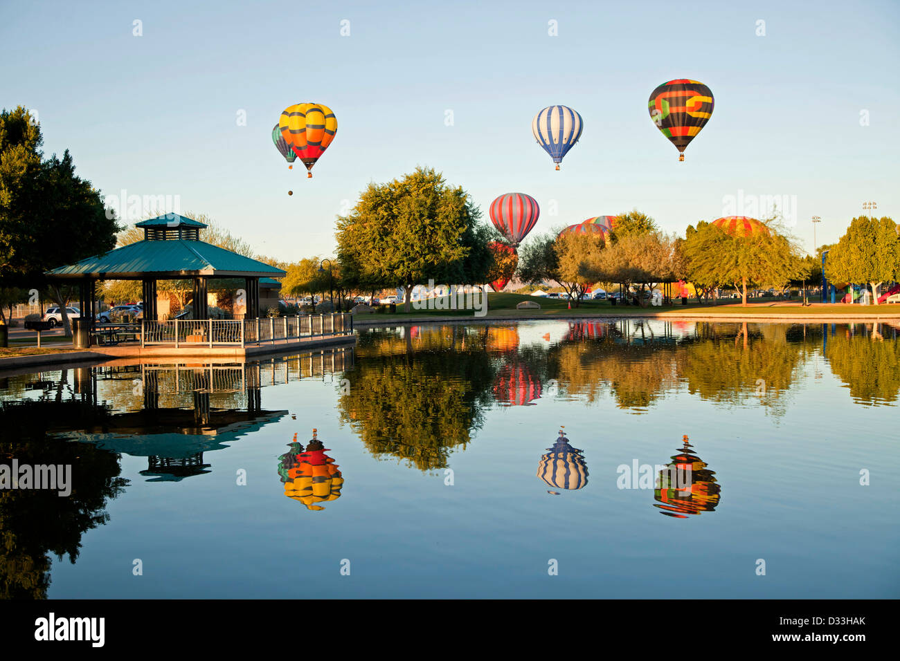 Hot Air Balloons at t he Yuma Balloon Festival reflected in a lake in