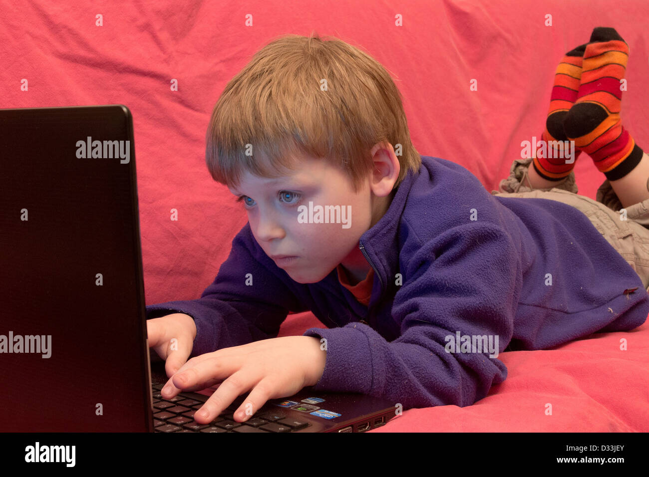 portrait of a young boy with a laptop Stock Photo