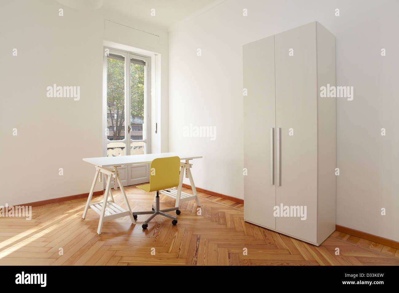Modern sunny apartment room with desk Stock Photo