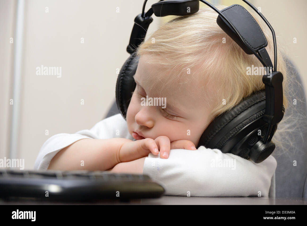 baby sleeps with headphones Stock Photo