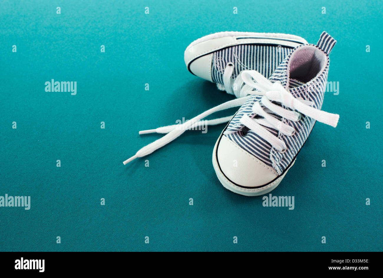 small baby sport shoes on blue background Stock Photo