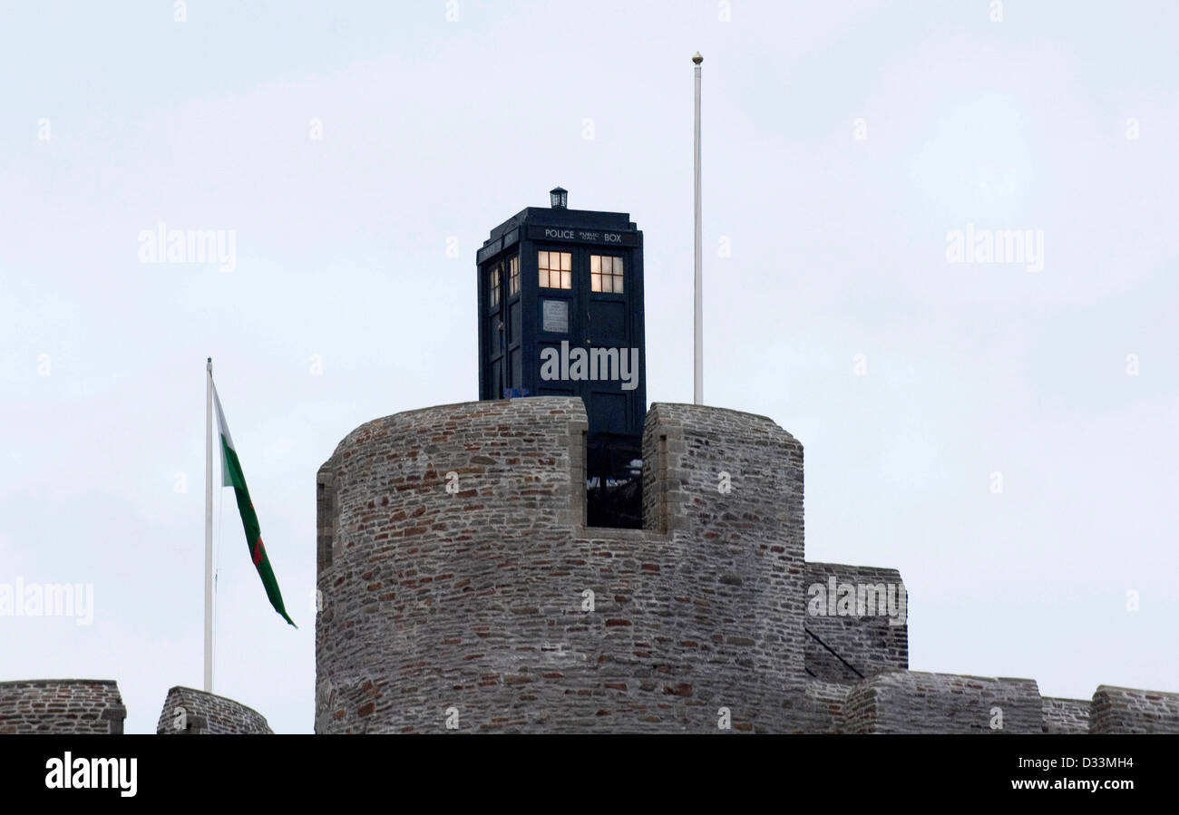 The Tardis from the television series of Dr Who lands on top of Caerphilly Castle - Wales’ largest moated medieval castle. Stock Photo