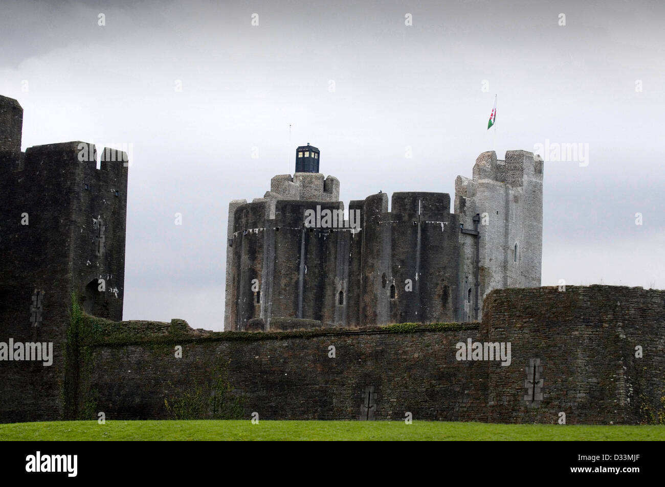 The Tardis from the television series of Dr Who lands on top of Caerphilly Castle - Wales’ largest moated medieval castle. Stock Photo