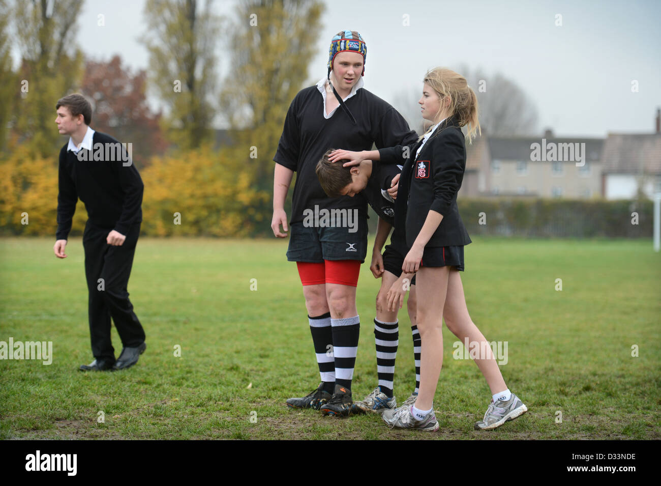 A girl joins a group of boys for a game of rugby at Pates Grammar School in Cheltenham, Gloucestershire UK Stock Photo