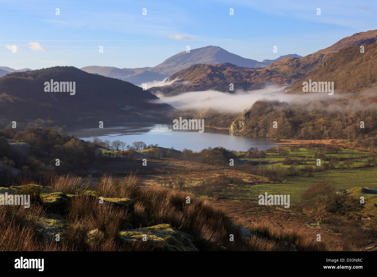 Scenic view along a valley to Llyn Gwynant lake with mist in mountains of Snowdonia National Park, Nantgwynant, North Wales, UK Stock Photo