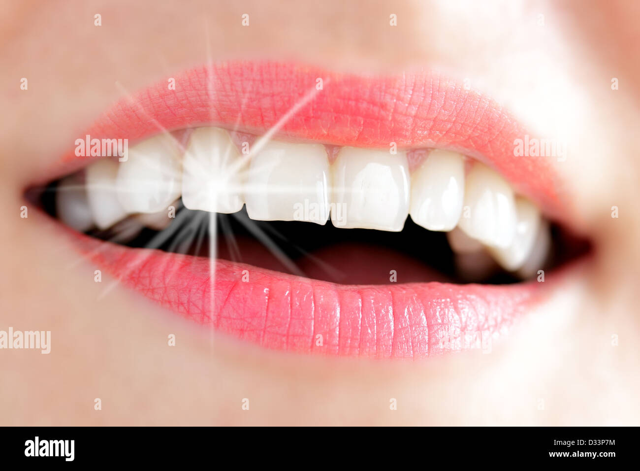 Teeth of a young woman with Light reflex Stock Photo